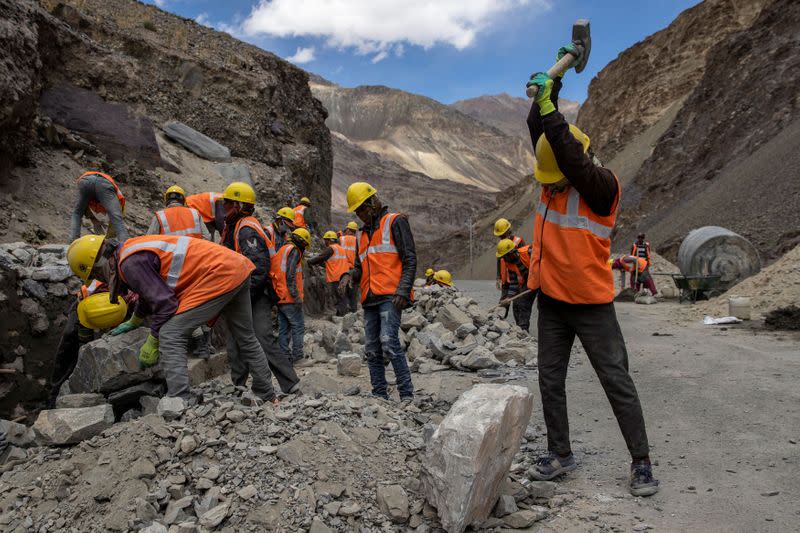 Labourers from the Border Roads Organisation (BRO) work on an under construction highway in the Ladakh region
