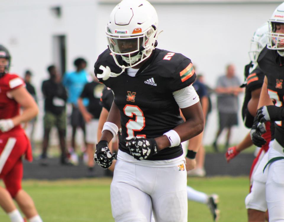 Jaime Ffrench runs off the after scoring a touchdown during a jamboree with Mandarin, St. Augustine and Bishop Kenny in spring football.