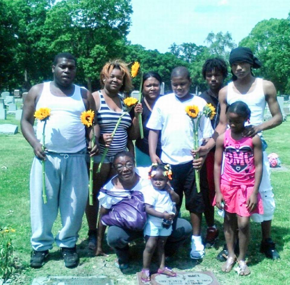 The family of Terrance Bridges, including his mother Rotonya McGee, visit his oldest brother’s grave.