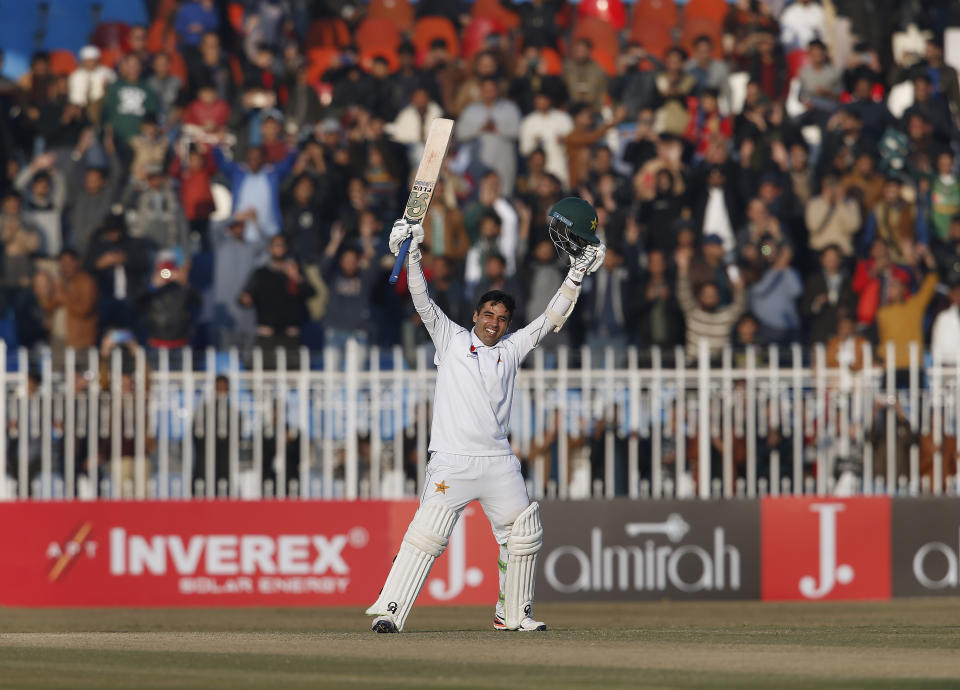 Pakistani batman Abid Ali celebrates after completing his century during the fifth-day of the 1st cricket test match between Pakistan and Sri Lanka, in Rawalpindi, Pakistan, Sunday, Dec. 15, 2019. (AP Photo/Anjum Naveed)