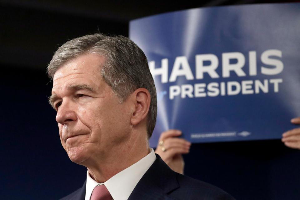 PHOTO: N.C. Gov. Roy Cooper listens to one of the other speakers at a news conference, July 25, 2024, in Raleigh, N.C.  (Chris Seward/AP)