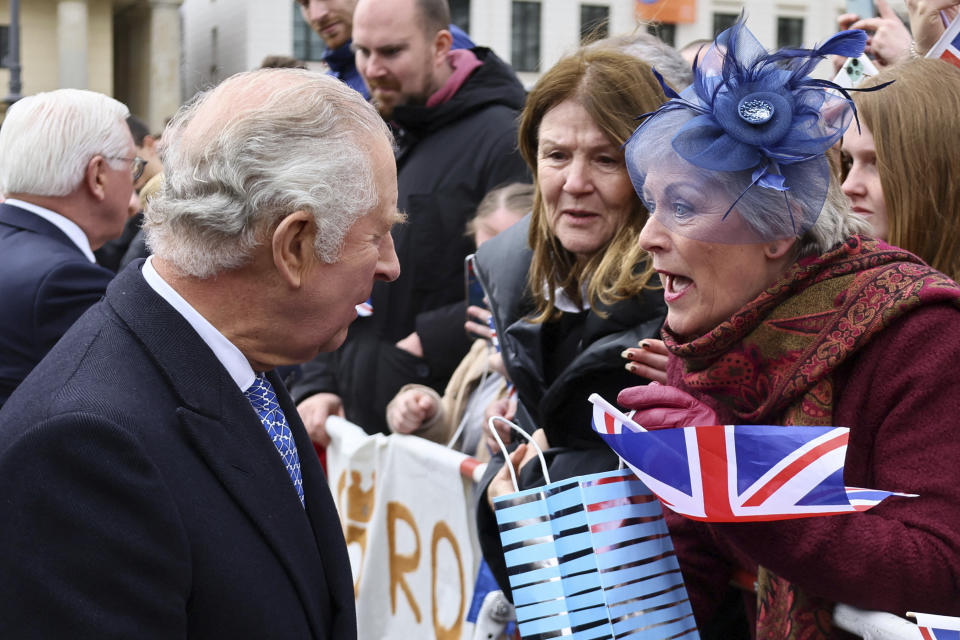 Britain's King Charles III greets a member of the public as he visits Berlin, Germany, March 29, 2023. (Wolfgang Rattay/Pool via AP)