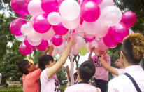 A Pink Dot participant hangs up notes containing hopes and dreams of the young. This was part of an initiative by community support group, Young Out Here. (Yahoo! photo/Melissa Law)