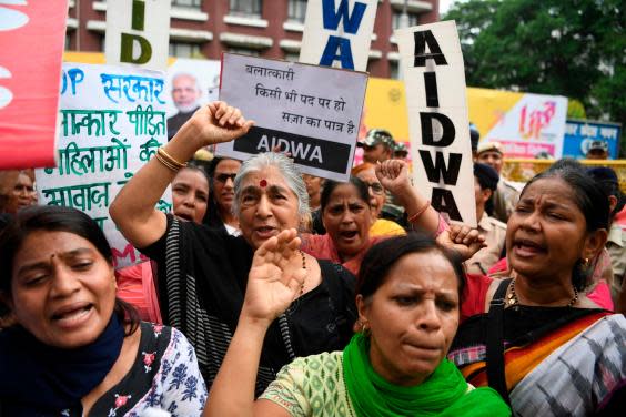 Social activists hold placards as they take part in a protest outside Uttar Pradesh Bhavan calling for action in a rape case in Uttar Pradesh, in New Delh (AFP/Getty Images)