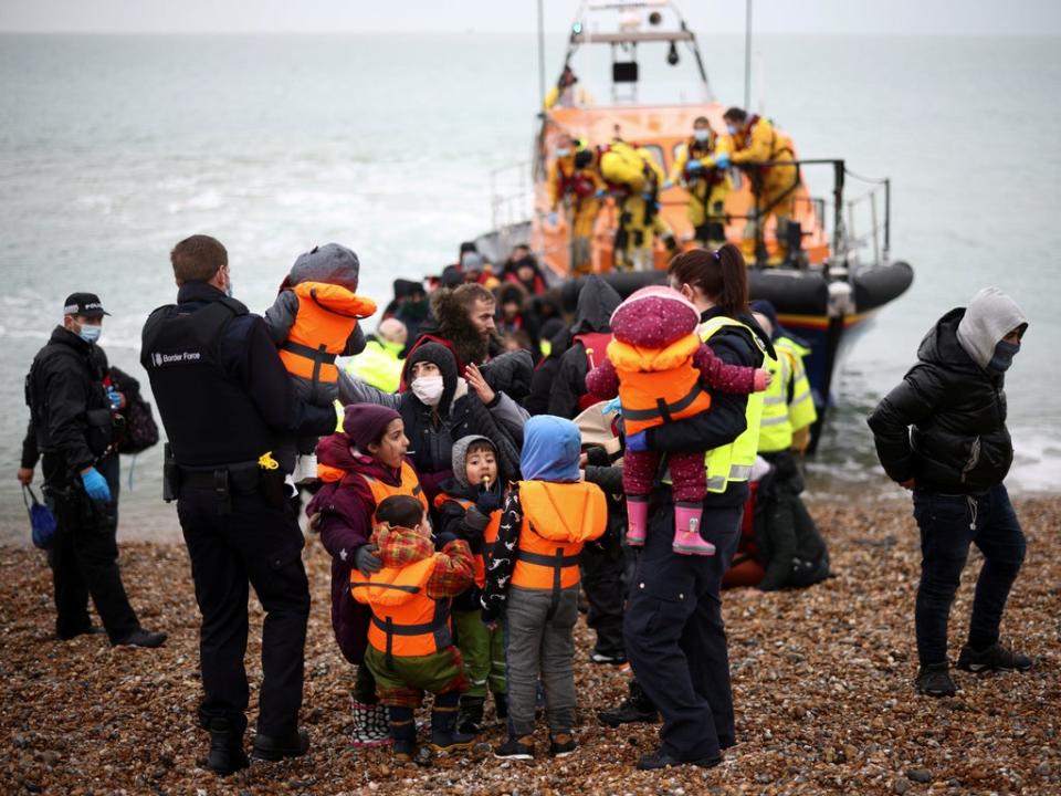 An RNLI boat and Border Force officers after a rescue in the English Channel (Henry Nicholls/Reuters)