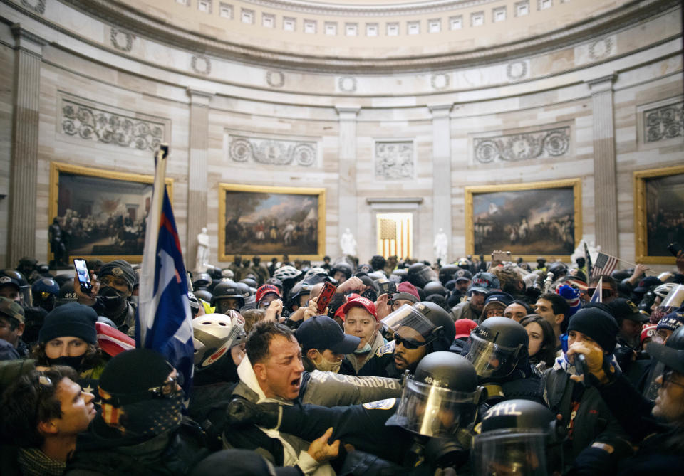 Police clash with Trump supporters inside the Capitol.