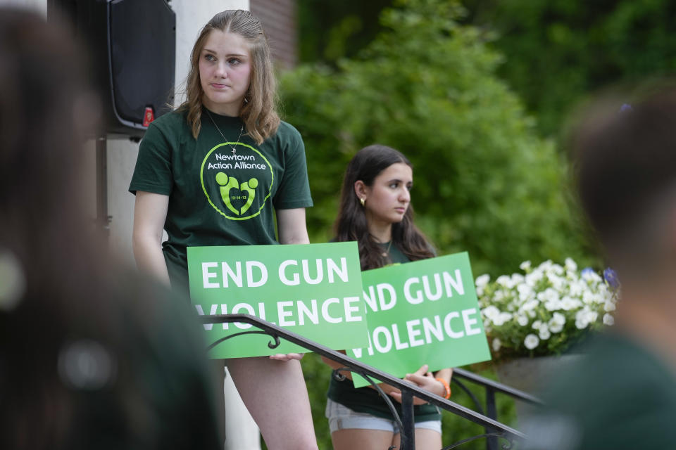 Members of Junior Newtown Action Alliance hold signs during a rally against gun violence on Friday, June 7, 2024 in Newtown, Conn. (AP Photo/Bryan Woolston)