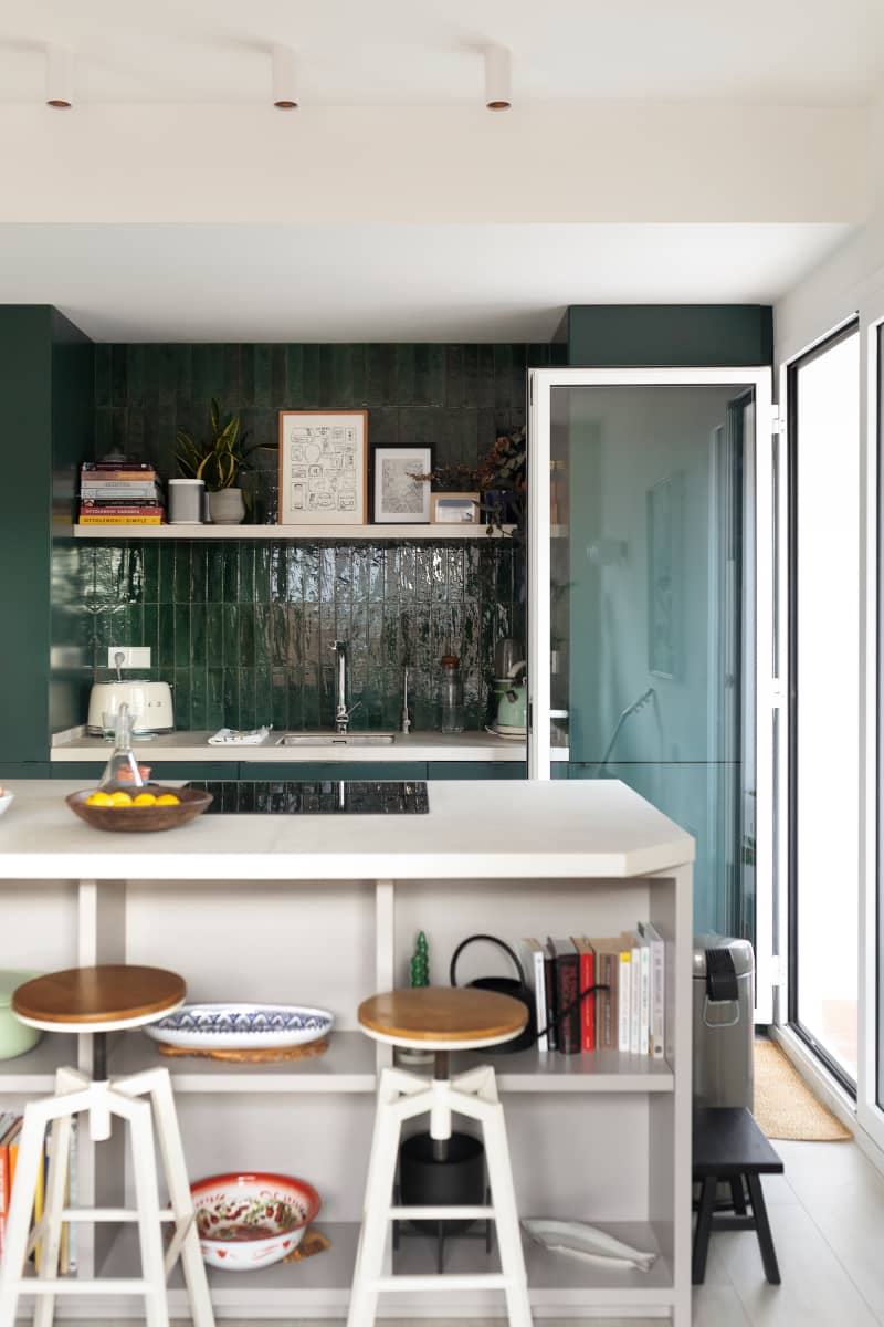 Green with green cabinets, green backsplash, and a white island.