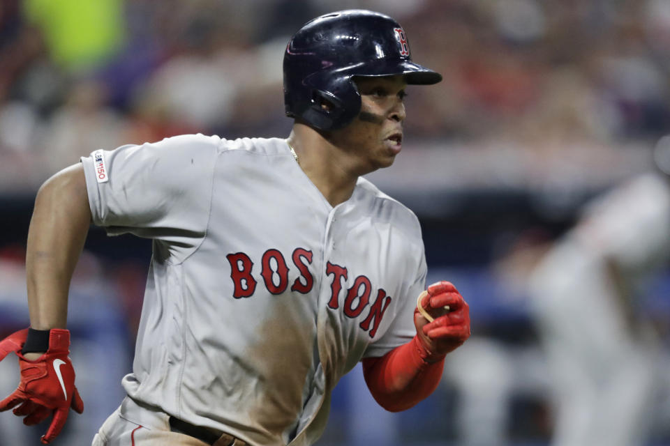 Boston Red Sox's Rafael Devers runs heads toward first on a two-run double during the sixth inning of the team's baseball game against the Cleveland Indians, Tuesday, Aug. 13, 2019, in Cleveland. (AP Photo/Tony Dejak)