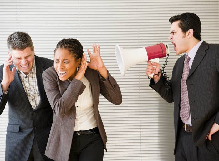 A man shouting at other people with a megaphone