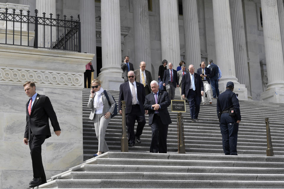 Members of the House of Representatives walk down the steps of Capitol Hill in Washington, Friday, March 27, 2020, after passing a coronavirus rescue package. Acting with exceptional resolve in an extraordinary time, the House rushed President Donald Trump a $2.2 trillion rescue package, tossing a life preserver to a U.S. economy and health care system left flailing by the coronavirus pandemic. (AP Photo/Susan Walsh)