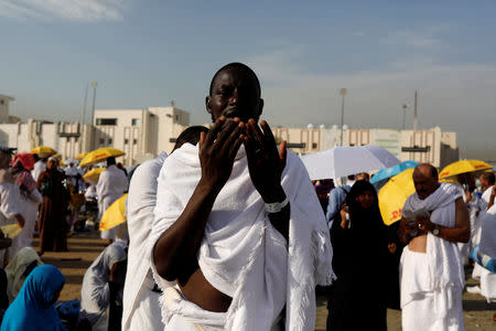 A Muslim pilgrim prays as he gather with others on Mount Mercy on the plains of Arafat during the annual haj pilgrimage, outside the holy city of Mecca, Saudi Arabia August 20, 2018. REUTERS/Zohra Bensemra