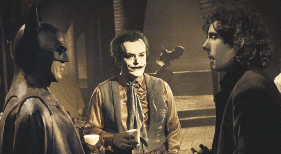 Michael Keaton in costume as Batman, Jack Nicholson in costume as Joker, with director Tim Burton, on-set of 1989's Batman. (Alamy)