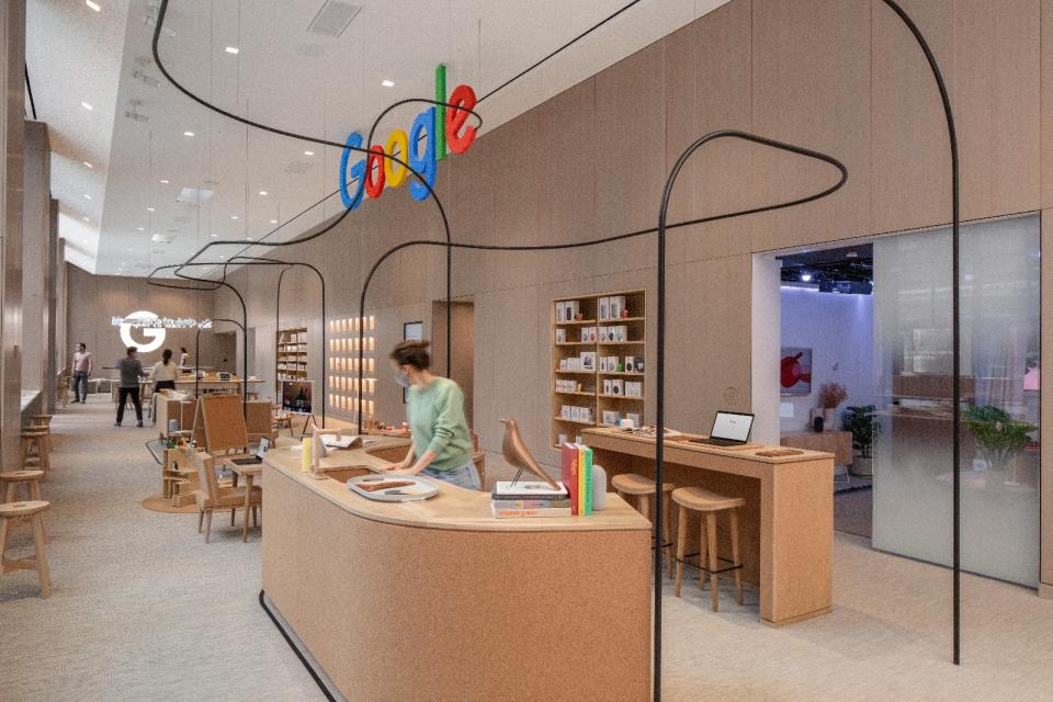<p>Google Store Chelsea. Interior, featuring several curving light wood desks and stools.</p>

