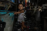 This photo taken on March 18, 2020 shows a child walking along a muddy path near his home in Manila. - Asian nations have imposed increasingly heavy measures to fight the outbreak of the COVID-19 coronavirus, the Philippines has ordered half its population of some 110 million to stay home. (Photo by Maria TAN / AFP) / TO GO WITH Health-virus-Philippines-poverty,FOCUS by Joshua Melvin and Ron Lopez (Photo by MARIA TAN/AFP via Getty Images)