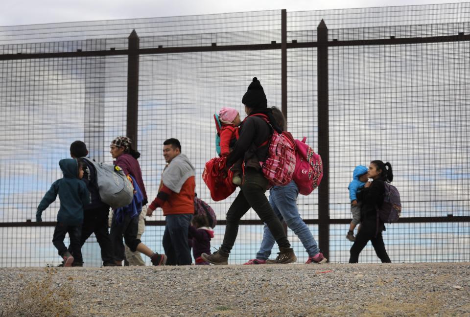 Central American immigrants walk along the border fence after crossing the Rio Grande from Mexico on February 01, 2019 in El Paso, Texas. The migrants turned themselves in to U.S. Border Patrol agents, seeking political asylum.