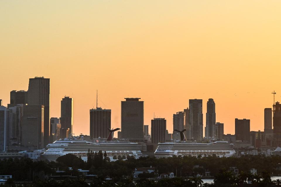 Docked cruise ships are seen at PortMiami in Miami at sunset on April 14, 2021. Cruise ships have been unable to sail in U.S. waters for more than a year.