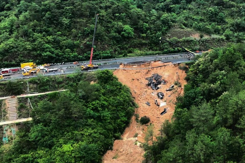 Rescuers working at the site of a collapsed road section of the Meizhou-Dabu Expressway in Meizhou (AP)