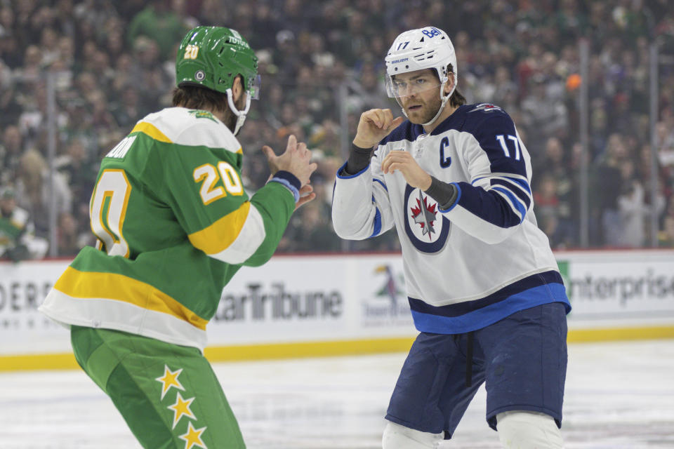 Winnipeg Jets center Adam Lowry (17) gets in a fight with Minnesota Wild left wing Pat Maroon (20) during the first period of an NHL hockey game Sunday, Dec. 31, 2023, in St. Paul, Minn. (AP Photo/Bailey Hillesheim)