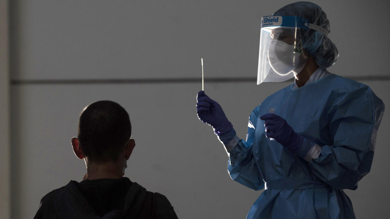 A health worker does a PCR test on a patient at Ficoba exhibition site, where mass coronavirus tests are being carried out on September 03, 2020 in Irun, Spain. (Gari Garaialde/Getty Images)