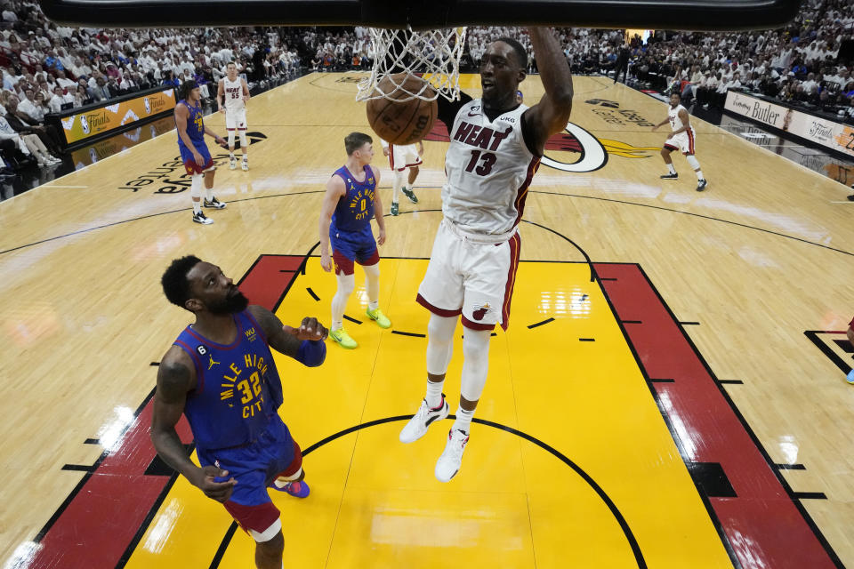 Miami Heat center Bam Adebayo (13) dunks the ball over Denver Nuggets forward Jeff Green (32) during the first half of Game 3 of the NBA Finals basketball game, Wednesday, June 7, 2023, in Miami. (AP Photo/Wilfredo Lee)