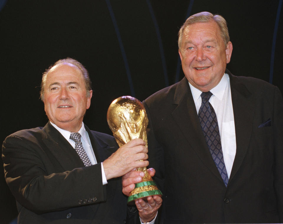 FILE - Switzerland's Sepp Blatter, left, and Swedish UEFA president Lennart Johansson hold a replica of the World Cup trophy in Paris, France, Monday June 8, 1998, after Blatter defeated Johansson and was elected FIFA president, the world 's soccer governing body. UEFA president Lennart Johansson lost to Sepp Blatter in a FIFA leadership election where stories swirled of payments to voters. (AP Photo/Francois Mori, File)