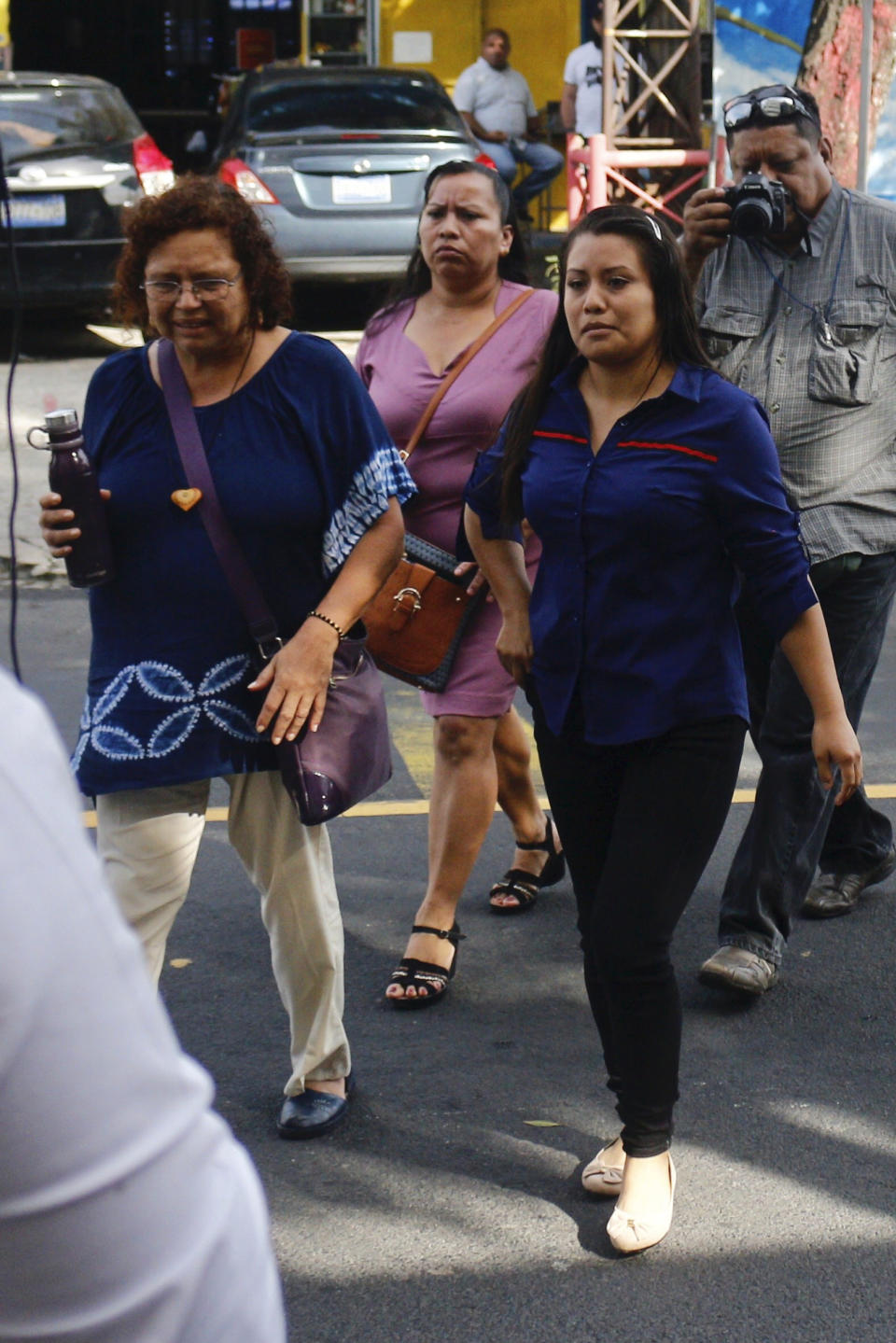 Evelyn Beatriz Hernandez, right, arrives to court for a new trial with a new judge, after her 30-year sentence for abortion was overturned in February, in Ciudad Delgado on the outskirts of San Salvador, El Salvador, Monday, July 15, 2019. The young woman who birthed a baby into a toilet in El Salvador faces a second trial for murder Monday, after having already served 33 months, in a case that has drawn international attention because of the country's highly restrictive abortion laws. (AP Photo/Salvador Melendez)