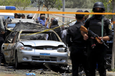 FILE PHOTO: Policemen secure the site of a car bomb attack on the convoy of Egyptian public prosecutor Hisham Barakat near his house at Heliopolis district in Cairo, Egypt, June 29, 2015. REUTERS/Mohamed Abd El Ghany/File Photo