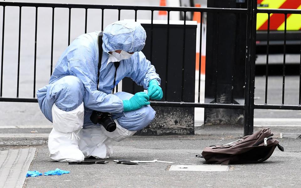 A police forensics officer collects evidence on Whitehall - Credit: Justin TALLISJUSTIN TALLIS/AFP/Getty Images