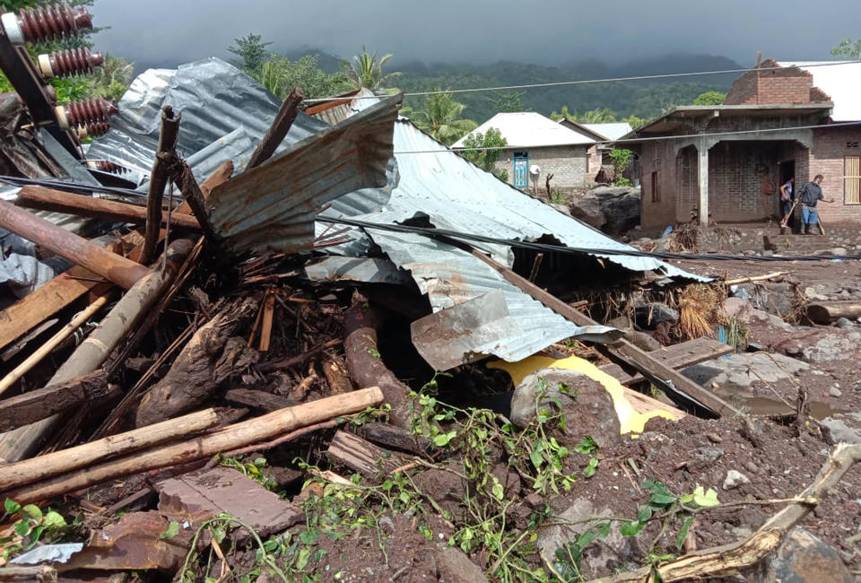 Villagers clean up mud and debris from their house following a flood in Ile Ape, on Lembata Island, East Nusa Tenggara province, Indonesia, Monday, April 5, 2021. Multiple disasters caused by torrential rains in eastern Indonesia and neighboring East Timor have left a number of people dead or missing as rescuers were hampered by damaged bridges and roads and a lack of heavy equipment Monday. (AP Photo/Ricko Wawo)