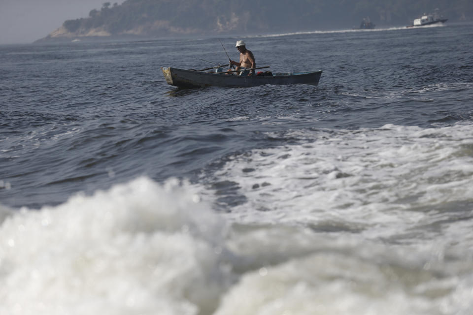 A man fishes on the Guanabara Bay in Rio de Janeiro, Brazil, Thursday, April 10, 2014. Many had hoped authorities tackle decades of neglect and poor planning that have blighted waterways, after Rio's Olympic committee pledged in writing that the pollution problems of Guanabara Bay will be fixed. (AP Photo/Silvia Izquierdo)