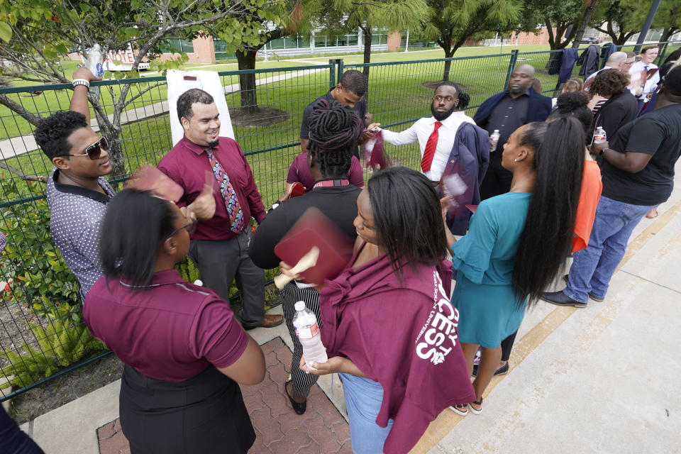 Texas Southern University students wait in the heat to enter a Democratic presidential primary debate hosted by ABC Thursday, Sept. 12, 2019, at Texas Southern University in Houston. (AP Photo/David J. Phillip)
