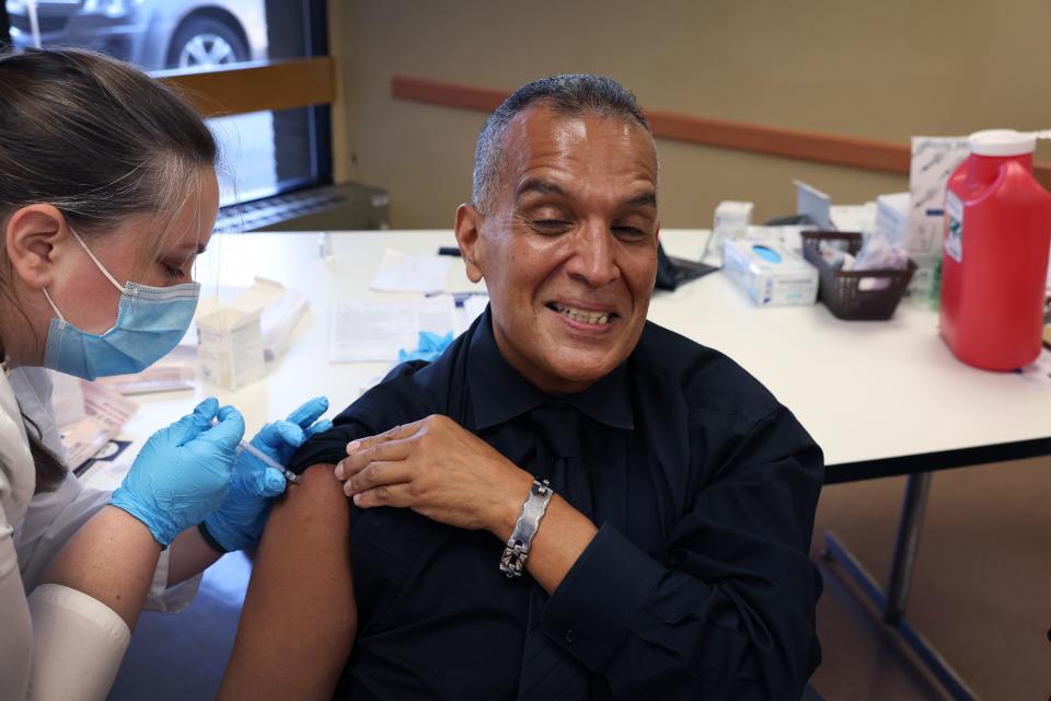 Felipe Sanchez gets a COVID-19 booster shot from pharmacist Patricia Pernal during an event hosted by the Chicago Department of Public Health at the Southwest Senior Center on September 09, 2022 in Chicago, Illinois. The recently authorized COVID-19 booster vaccine protects against the original SARS-CoV-2 virus and the more recent omicron variants, BA.4 and BA.5.