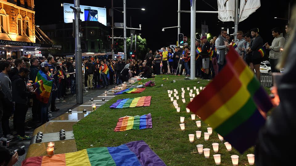 People gather at a vigil in solidarity for the victims of the Orlando nightclub mass shooting at Taylor Square. Photo: AAP