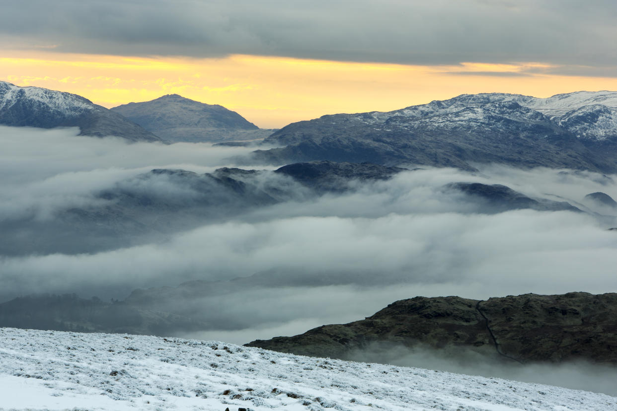 Red Screes above Ambleside with mist from a temperature inversion, Lake District, UK, looking towards Harter Fell.