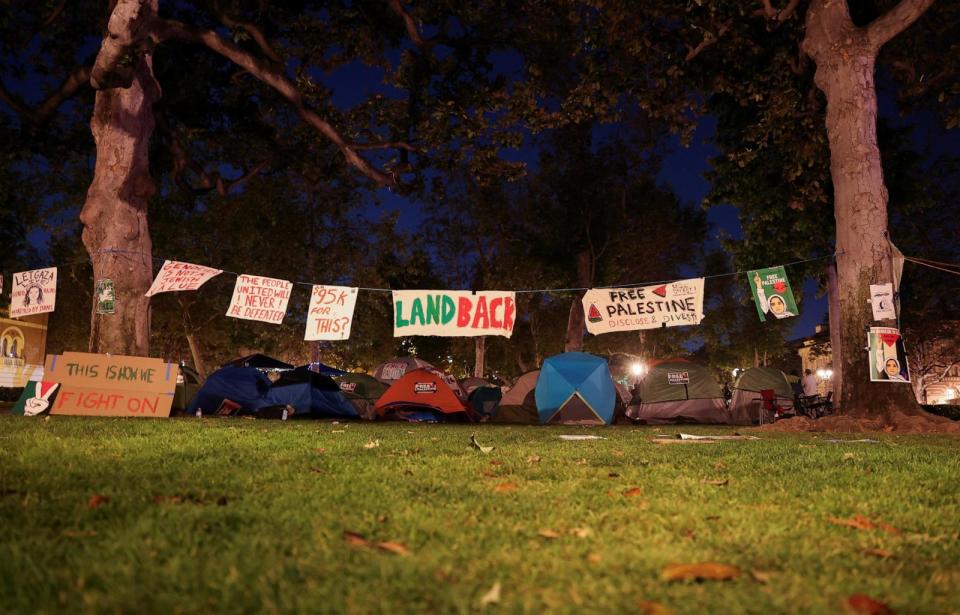 PHOTO: Posters hang near tents at the University of Southern California (USC) during a protest in support of Palestinians in Gaza, amid the ongoing conflict between Israel and the Palestinian Islamist group Hamas, in Los Angeles, on April 27, 2024.  (Aude Guerrucci/Reuters)