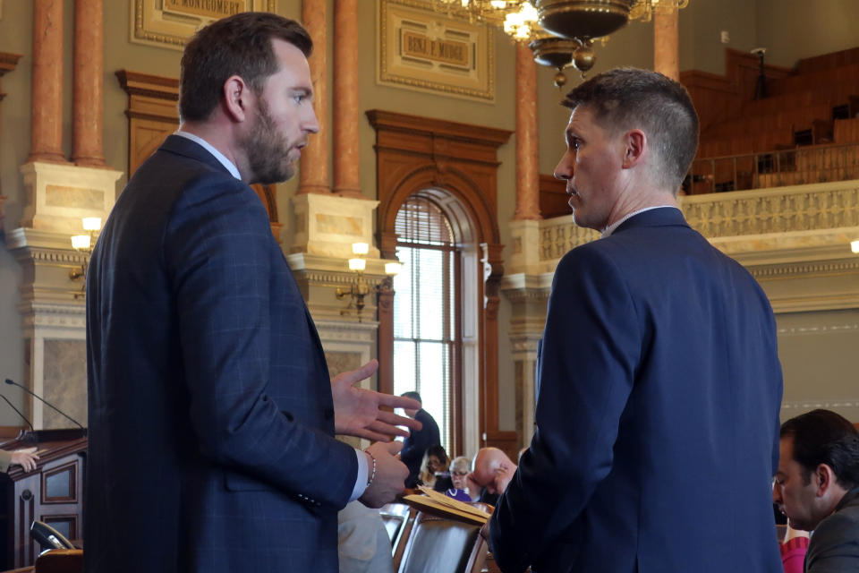 . Brandon Woodard, left, D-Lenexa, argues with Rep. Steve Howe, right, R-Salina, over committee testimony about a bill that would restrict diversity, equity and inclusion initiatives on university campuses following a House debate on the bill, Wednesday, March 20, 2024, at the Statehouse in Topeka, Kan. Howe is the chair of the committee that drafted the bill and Woodard is its ranking Democrat. (AP Photo/John Hanna)