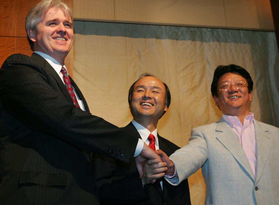 Japan's Internet services company Softbank President Masayoshi Son, center, shakes hands with Vodafone's Japan unit Vodafone KK President Bill Morrow, left, and Yahoo Japan President & chief executive Masahiro Inoue during a news conference announcing Softbank is acquiring a 97.7 percent stake in British mobile phone company Vodafone's struggling Japan unit at a Tokyo hotel Friday, March 17, 2006. Son told reporters the deal, expected to be final in a month or two, is valued at 1.75 trillion yen (US$15 billion; euro12 billion), in a move that will greatly boost its foray into the cell phone bu