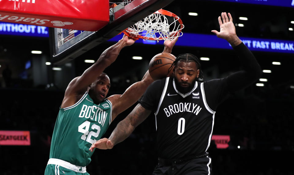 Boston Celtics center Al Horford (42) dunks against Brooklyn Nets center Andre Drummond (0) during the first half of an NBA basketball game, Thursday, Feb. 24, 2022, in New York. (AP Photo/Noah K. Murray)