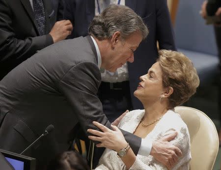 Colombian President Juan Manuel Santos greets Brazilian President Dilma Rousseff before the start of the Paris Agreement signing ceremony on climate change held at the United Nations Headquarters in Manhattan, New York, U.S., April 22, 2016. REUTERS/Brendan McDermid