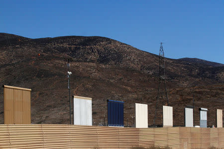 Prototypes for U.S. President Donald Trump's border wall with Mexico are shown near completion behind the current border fence, in this picture taken from the Mexican side of the border, in Tijuana, Mexico, October 23, 2017. REUTERS/Jorge Duenes