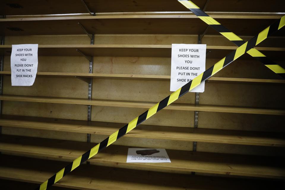 The shoe rack is taped off for safety measures at Minhaj-ul-Quran Mosque, at the start of Eid al-Adha, in London, Friday, July 31, 2020. Muslims worldwide marked the the Eid al-Adha holiday over the past days amid a global pandemic that has impacted nearly every aspect of this year's celebrations. (AP Photo/Kirsty Wigglesworth)