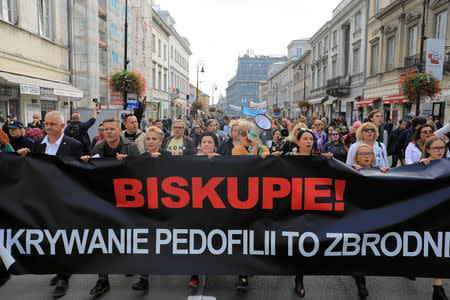 People take part during a demonstration against pedophilia 'Hands away from children' in Warsaw, Poland October 7, 2018. Banner reads 'Bishop, hiding pedophilia is a crime'. Picture taken October 7, 2018. Agencja Gazeta/Jacek Marczewski via REUTERS