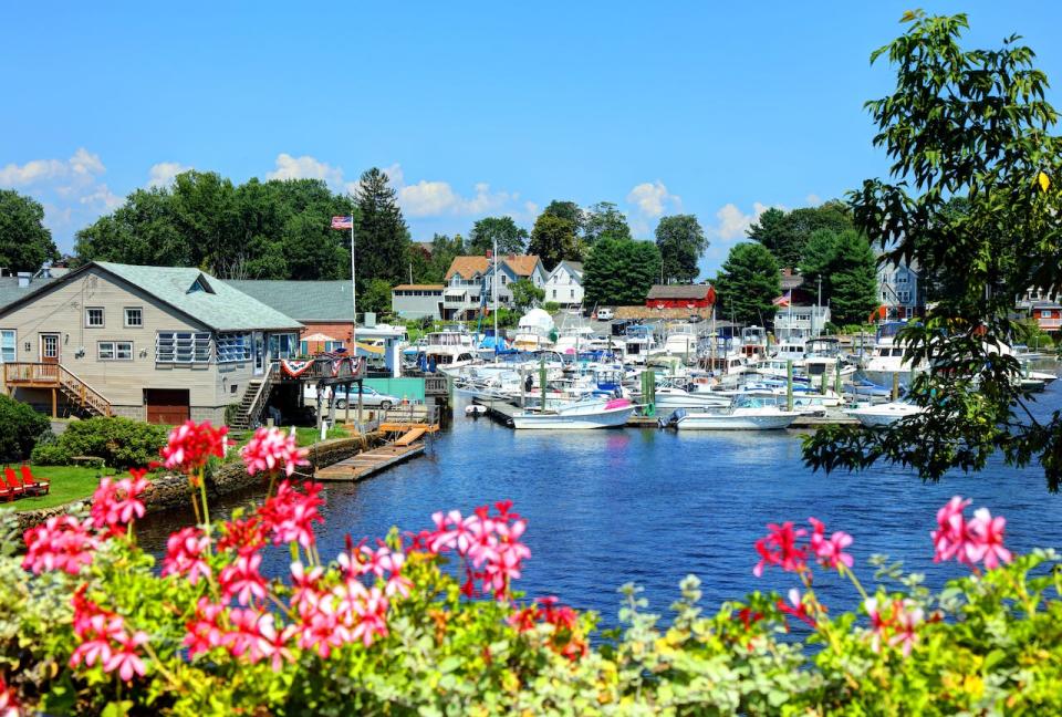 A view of a marina lined with boats and houses in Pawtuxet Village, Rhode Island.