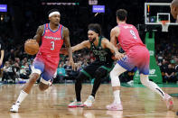 Washington Wizards guard Bradley Beal (3) drives past Boston Celtics guard Derrick White on a screen by Wizards' Deni Avdija, right, during the first half of an NBA basketball game Sunday, Nov. 27, 2022, in Boston. (AP Photo/Mary Schwalm)