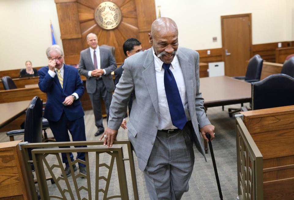 Perry Lott leaves the courtroom as Barry Scheck, founder of the Innocence Project, wipes his eyes after Lott's conviction was vacated by Pontotoc County District Judge Steven Kessinger.