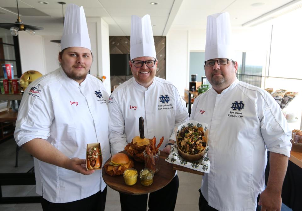 Senior Executive Chef Travis Johnson, center, leads a culinary team that has developed a number of new options for fans coming to Notre Dame Stadium. While maintaining the old standards, the team has added some new options for stadium visitors this year. Other members of the team include Albert Armstrong-Ingram, senior sous chef, on the left, and Ryan Martin, executive chef.