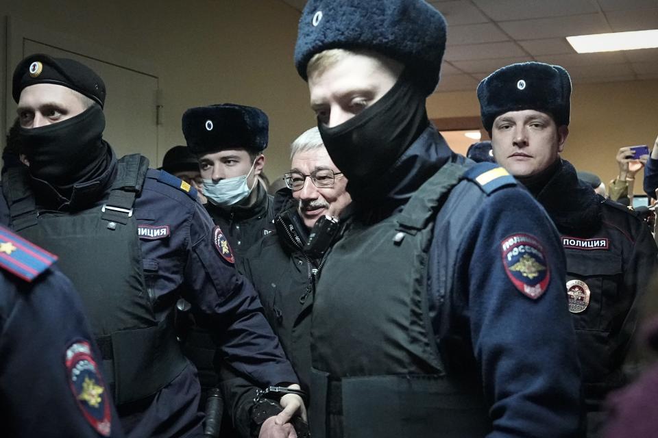 FILE – Oleg Orlov, the co-chair of the Memorial Human Rights Center, is escorted by police in a Moscow court on charges of repeated discrediting Russian military, in Moscow, Russia, on Tuesday, Feb. 27, 2024. Over the last decade, Vladimir Putin's Russia evolved from a country that tolerates at least some dissent to one that ruthlessly suppresses it. Arrests, trials and long prison terms — once rare — are commonplace. (AP Photo, File)