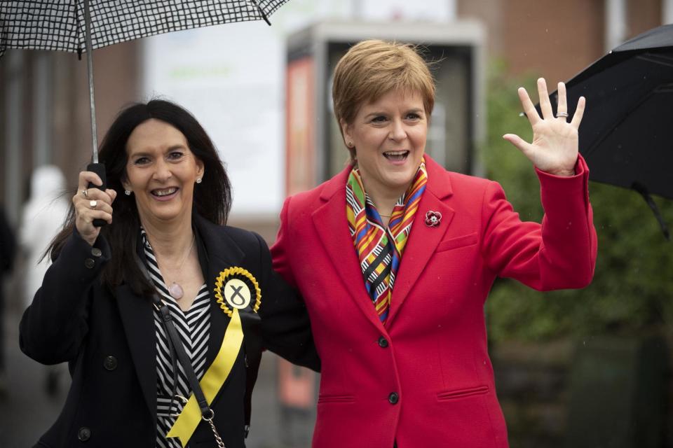 SNP leader Nicola Sturgeon (right) with Margaret Ferrier, SNP candidate for Rutherglen, during her visit to Burnside Pharmacy in Rutherglen (PA)