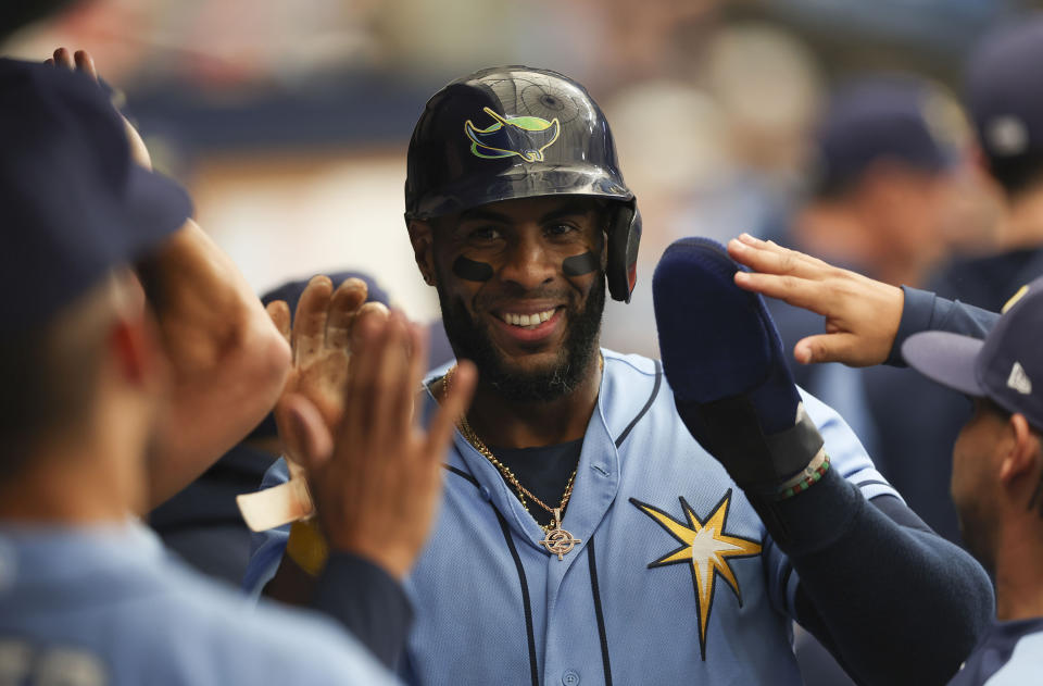Tampa Bay Rays' Yandy Diaz reacts in the dugout after scoring against the Texas Rangers during the third inning of a baseball game Sunday, Sept. 18, 2022, in St. Petersburg, Fla. (AP Photo/Mark LoMoglio)